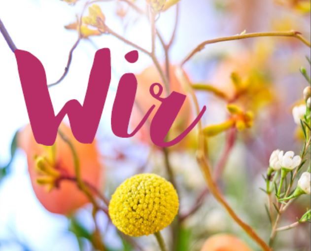 Titelfoto Wir Nr. 74 - mit bunten Frühlingsblumen im Hintergrund